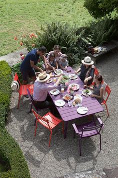 a group of people sitting around a purple table