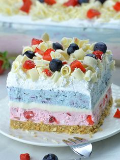 a piece of ice cream cake on a plate with berries and pasta all over it