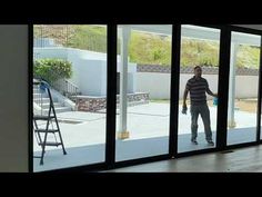 a man standing in front of a sliding glass door