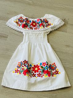 100% Authentic Mexican Dress  This Dress is gorgeous. size:4T This dress can fit up to 4 Color: white  Embroidery Mexican Dress. Boho Chic Dress Folk Fabric Flowers Mexican Tunic Traditional Embroidery This Dress is perfect for those beach day or any occasion This Dress is meant to provide extreme comfort throughout the day The perfect gift for her Short Sleeve Embroidered Dresses For Beach Season, Summer Dresses With Floral Embroidery For Beach Season, Summer Embroidered Dresses For Beach Season, Spring Vacation Embroidered Sundress, Embroidered Summer Sundress For Vacation, Fitted Embroidered Beach Sundress, Embroidered Fitted Beach Sundress, Embroidered Fitted Sundress For Beach, Summer Dress With Embroidered Hem And Short Sleeves