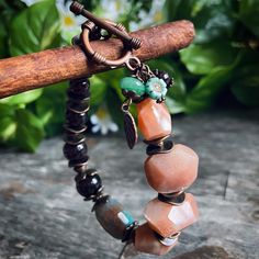 This gorgeous luxurious bracelet is made with peach moonstone and garnet gemstones, agate focal bead, tiny glass charms and copper findings. It is perfect for special occasion or just for an everyday wear to create an accent. It looks gorgeous on and It is a perfect gift for a loved one and it comes in a gift box ready for gifting!🎁 #gemstonejewelry #statementjewelry #giftforher #etsyseller #handmadebracelet Earthy Beaded Bracelets With Natural Stones, Bohemian Crystal Bracelet With Czech Glass Faceted Beads, Bohemian Agate Gemstone Beads Bracelets, Bohemian Agate Crystal Bracelet Hand-strung, Bohemian Czech Glass Crystal Bracelet With Faceted Beads, Bohemian Agate Hand-strung Crystal Bracelet, Brown Agate Beaded Bracelet With Gemstones, Bohemian Agate Crystal Bracelet With Gemstone Beads, Brown Agate Gemstone Beaded Bracelet