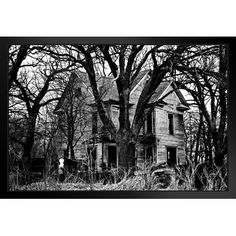 an old house in the woods with no leaves on it, and trees around it