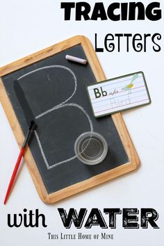 a blackboard with writing on it next to a marker and some tape, pencils and markers