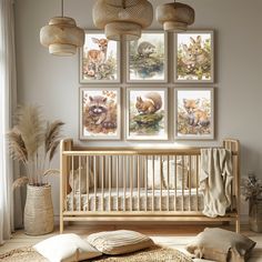 a baby's room with four pictures on the wall and a crib next to it