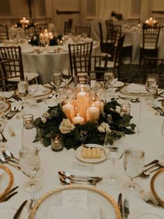 a table set with candles and place settings