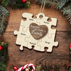 a puzzle piece with the words together we make a family on it next to christmas decorations