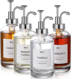 three different types of soap dispensers in glass bottles with metal faucets