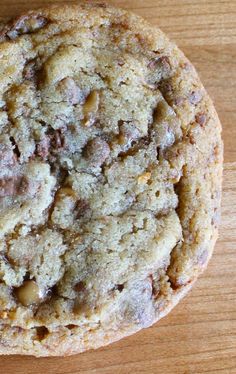 a chocolate chip cookie sitting on top of a wooden table