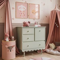 a baby's room decorated in pink and green