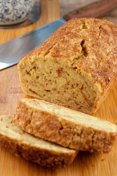 a loaf of bread sitting on top of a wooden cutting board next to a knife