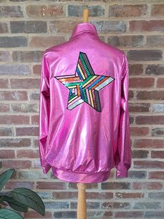 "Holographic Pink Jacket with sequined colourful star applique to back Ideal for festivals, gigs and themed events Zip up bomber style jacket with stunning fully sequined multi coloured star applique to the back of the jacket The jacket material is a shiny metallic look polyester with a holographic sheen. Available in two sizes: SIZING (length taken from back of neck to hem) : S/M :    38-40\" Chest   - Length  65cm    M/L :    42-44\" Chest  -  Length 62cm Measured across the front with zip closed - (underarm - underarm) : S/M :   56cm (22\") M/L :  58cm (23\")  Other colour jackets are also available. Drop me a Etsy message if you have any questions about this jacket, or if you need any more measurements, and I will get back to you." Holographic Jacket, Star Applique, Star Festival, Pink Holographic, Dungarees Shorts, Metallic Look, Rose Party, Festival Clothing, Themed Events