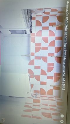 a bathroom with pink and white tiles on the walls