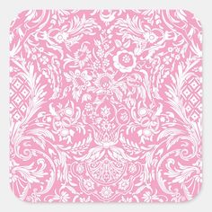 a pink and white square sticker with an ornate design