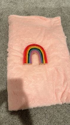 a pink blanket with a rainbow on it