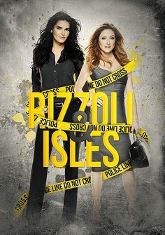 two women standing next to each other in front of a black and yellow sign that says rizzoli isles