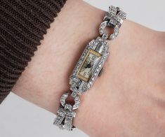 "Waltham 1920s Watch This antique Waltham watch is platinum and covered in 2 carats of diamonds! Quite the elegant timepiece! There is a beautiful mixture of single cut and baguette diamonds. The clasp is a two part latch for extra safety! This piece has been evaluated by an expert, and it works wonderfully. Antique Watch - Antique Ladies Waltham 1920's Platinum Diamond Wrist Watch Waltham 1920's Platinum Total Diamond Weight is 2cts Watch length measures approximately 7\" long. Please read thro Waltham Watch, Antique Wedding Bands, Antique Watch, Watch Jewelry, Gold Diamond Wedding Band, Antique Wedding, Vintage Wedding Band, Antique Watches, Roaring Twenties