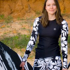 This Women's UPF 50+ Hawaiian Hibiscus Rash Guard offers superior sun protection with a UPF 50+ rating, while its seamless paddle zones, longer body and sleeves provide extra coverage. Featuring a black and white Hawaiian floral print, it is the perfect choice for any swim, surf, snorkel, or paddleboarding excursion. • 82% polyester, 18% spandex • 6.78 oz. • Soft four-way stretch • Fitted design • UPF 50+ • Longer body and sleeve cut • Seamless Paddlezones - Flatseam and coverstitch This product Long Sleeve Beachwear Swimwear For Outdoors, Long Sleeve Beachwear For Outdoor, Casual Rash Guard For Surfing With Upf 50+, White Beachwear Swimwear For Outdoor, Long Sleeve Rash Guard For Beach Season Water Sports, Long Sleeve Rash Guard For Water Sports, Long Sleeve Rash Guard For Water Sports, Beach Season, White Surfing Tops With Upf 50+, White Upf 50+ Surfing Top