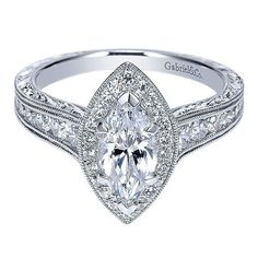 a white gold engagement ring with a pear shaped diamond center