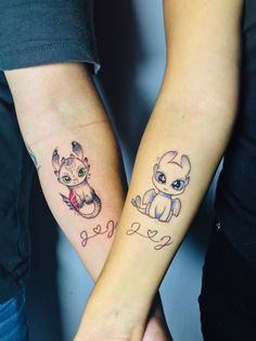 two people holding hands with tattoos on their arms and one has a small baby in the middle