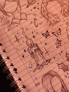 an open notebook with drawings on it