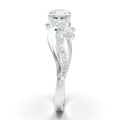 a white gold ring with an oval cut diamond in the center