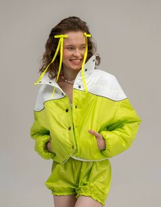 Jacket is made of raincoat fabric, has a lightweight insulation and a high collar, as well as a button closure and sleeves with hidden elastic. Among its special features is a reflective stripe along the yoke, which provides safety and visibility in the dark, as well as pockets that add convenience and functionality. The jacket is very lightweight and comfortable, making it ideal for use in the transitional seasons, when the temperature is not cold enough to wear heavy winter jackets. Available Sporty Nylon Track Jacket With Reflective Details, White Sporty Outerwear With Reflective Details, Nylon Hooded Track Jacket With Reflective Details, Urban Long Sleeve Track Jacket With Reflective Details, Long Sleeve Nylon Windbreaker With Reflective Details, Seven Eleven, Green Jacket, Special Features, High Collar