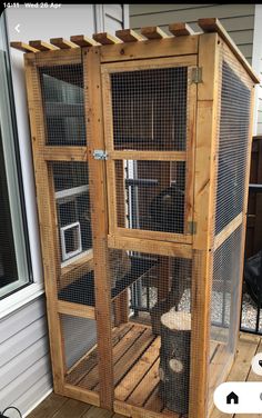 a large wooden bird cage sitting on top of a hard wood floor