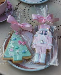 two decorated cookies sitting on top of a plate