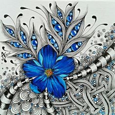 a blue flower is in the middle of an artistic drawing