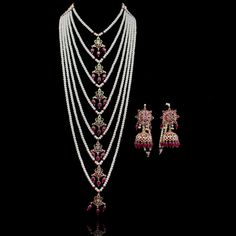 Radiating the elegance of our culture, this heritage piece speaks of sophistication and excellence! Exuding old-world charm, this set is strung together with beautiful stones and complementing pearl moti. Approximate mala length is 19". The set includes a pair of matching earrings. Approximate earrings length is 3". Gold-plated on high-quality brass as the base metal. Mahira Set (Emerald) is in-stock & ready-to-ship. Delivery time frame for the Mahira Set (Ruby) & Mahira Set (Sapphire) is 4-6 we Traditional Ceremonial Pearl Necklace With Stone Work, Traditional Pearl Bridal Necklace With Tilla, Traditional Bridal Pearl Necklace With Tilla, Traditional Pearl Bridal Necklace For Ceremonial Occasions, Bollywood Style Pearl Necklace For Diwali Ceremonies, Traditional Pearl Mala For Festive Occasions, Bollywood Necklace With Tilla And Traditional Drape, Bollywood Bridal Necklace For Rituals With Latkans, Traditional Pearl Necklace With Stone Work For Festive Occasions