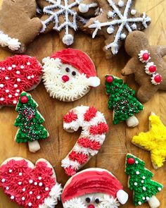 decorated cookies are arranged in the shape of santa claus and other christmas decorations on a wooden table