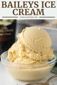 a bowl filled with ice cream next to a spoon and bottle of bailey's ice cream