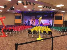 an empty auditorium with rows of colorful chairs