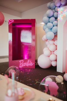 balloons and decorations are set up for a barbie birthday party