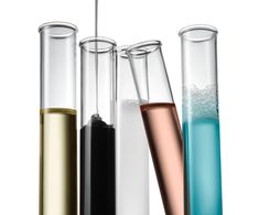 three test tubes filled with different colored liquids