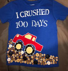 a blue shirt that says i crushed 100 days with a red truck on it