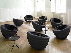 a group of black chairs sitting on top of a wooden floor