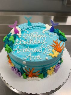 a birthday cake with blue frosting and colorful decorations