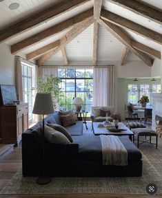 a living room filled with furniture and a fire place in the middle of a room