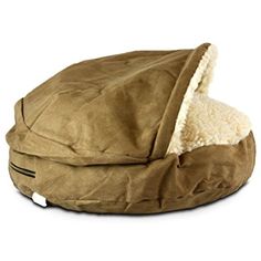 a dog bed with a hood on it's back and a white background behind it