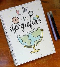 a notebook with the words geografia written on it and a pen next to it