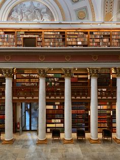 the interior of a library with columns and bookshelves