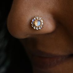 "Enchanting rainbow Moonstone floral stud, crafted in solid 14k 18k gold in a mesmerizing bezel and prong mixed setting. The cabochon cut of the natural moonstones with a subtle blue sheen render calmness, like fragrant flowers of heaven. This stud makes a bold piece for your nostril piercing, a unique pick for your philtrum and a comfortable everyday pair for your ears. Versatile and stunning. It is available as single and pair with different backing styles to suit various piercings. Please refer last image.  *  Gold: 14k/18k Solid Gold  *  Gold Colour: Yellow / Rose / White  *  Gold Wt.: ~0.80 gm (14kt) *  Gemstone: Natural Rainbow Moonstone *  Moonstone Size: ~4 mm (Centre) + 1.5mm (Halo) *  Moonstone Cut: Round Cabochon  *  Moonstone Wt.: ~0.60 Ct *  Please refer last image for backing Gold Multi-stone Moonstone Jewelry, Yellow Gold Multi-stone Moonstone Jewelry, Gold Cabochon Gemstones For Wedding, Bild Gold, Ear Piercing Jewelry, Nostril Piercing, Floral Studs, Nose Ring Stud, Fragrant Flowers