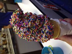 an ice cream cone filled with sprinkles on top of a white counter