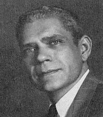 black and white photograph of a man in suit and tie looking off to the side