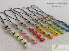 a bunch of different colored beads on a white surface with the words summer collection charms