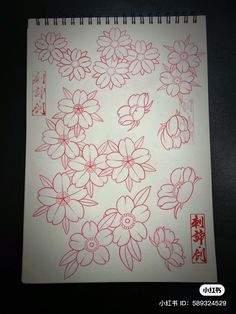 a notebook with flowers drawn on it and chinese writing in the middle, next to an image of red ink