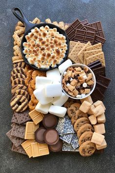 a platter filled with cookies, marshmallows and other snacks