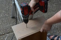 a person using a cordless driller on a piece of wood