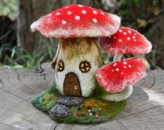 a small mushroom house sitting on top of a tree stump